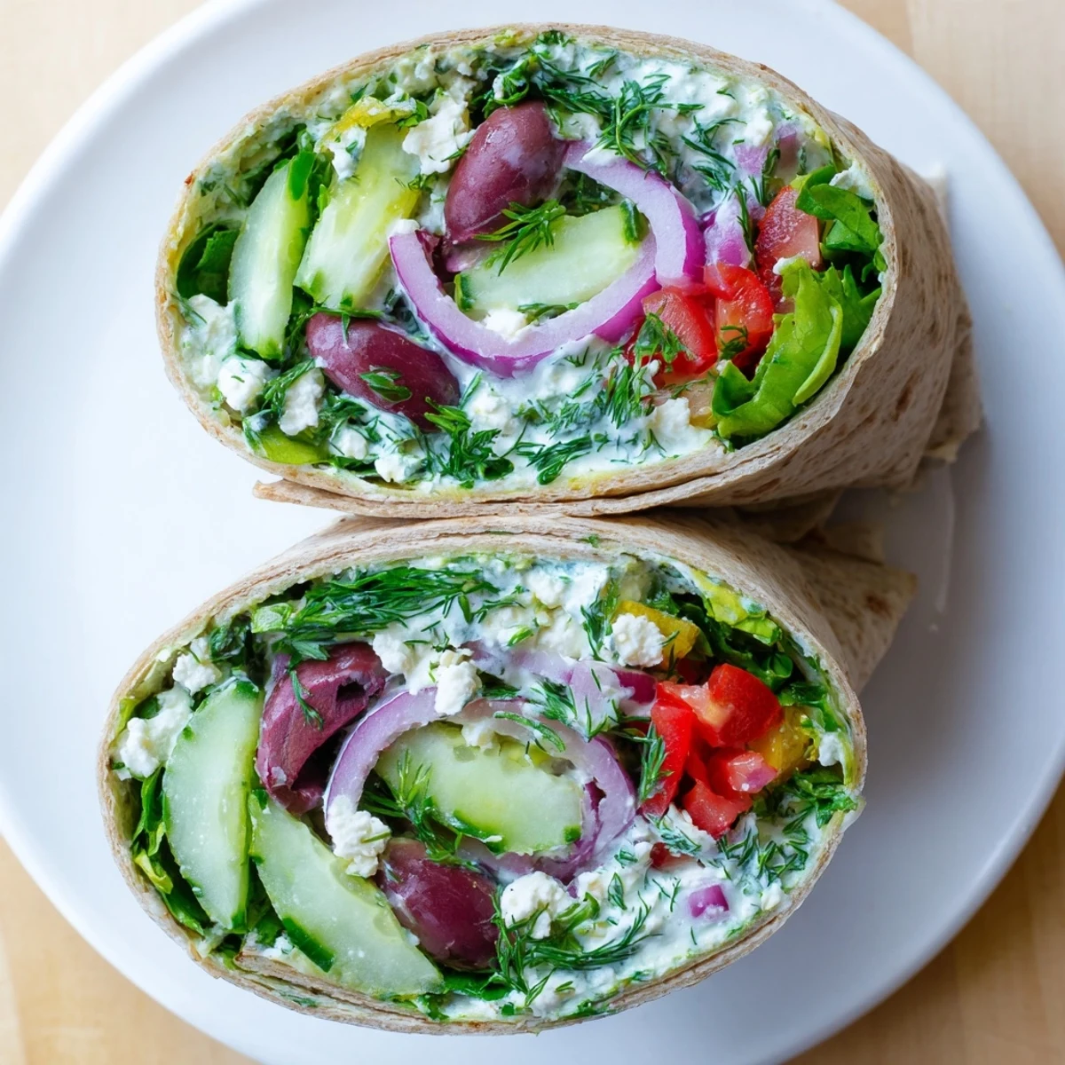 Brightly lit Mediterranean Wrap with Feta and Olives, garnished with fresh dill and ready for a quick vegetarian lunch.