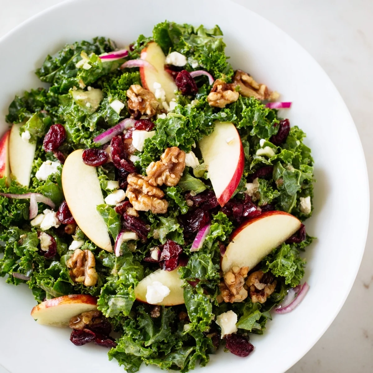 Freshly massaged kale, sliced apples, and toasted walnuts tossed in a tangy maple-Dijon dressing for a vibrant salad.