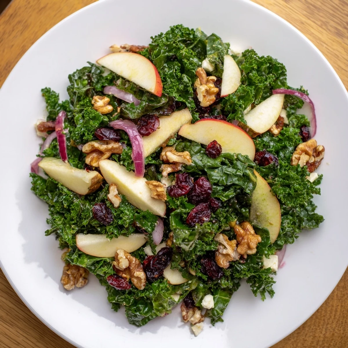 A close-up of Green Kale and Apple Salad with Walnuts, ready to serve as a healthy vegetarian side dish.
