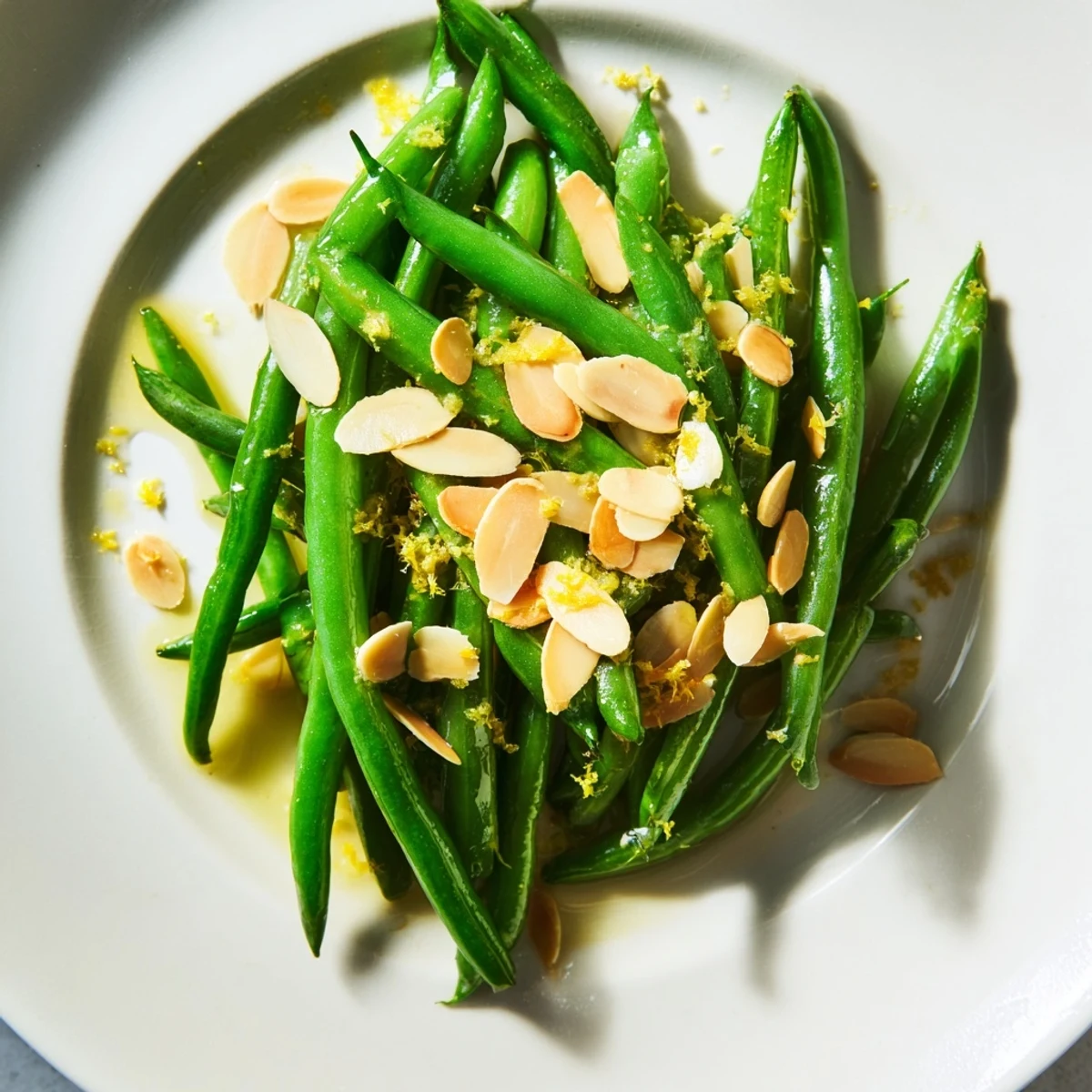 Vibrant green beans with lemon and almonds highlighted with buttery toasted nuts, perfect alongside roasted chicken or salmon.