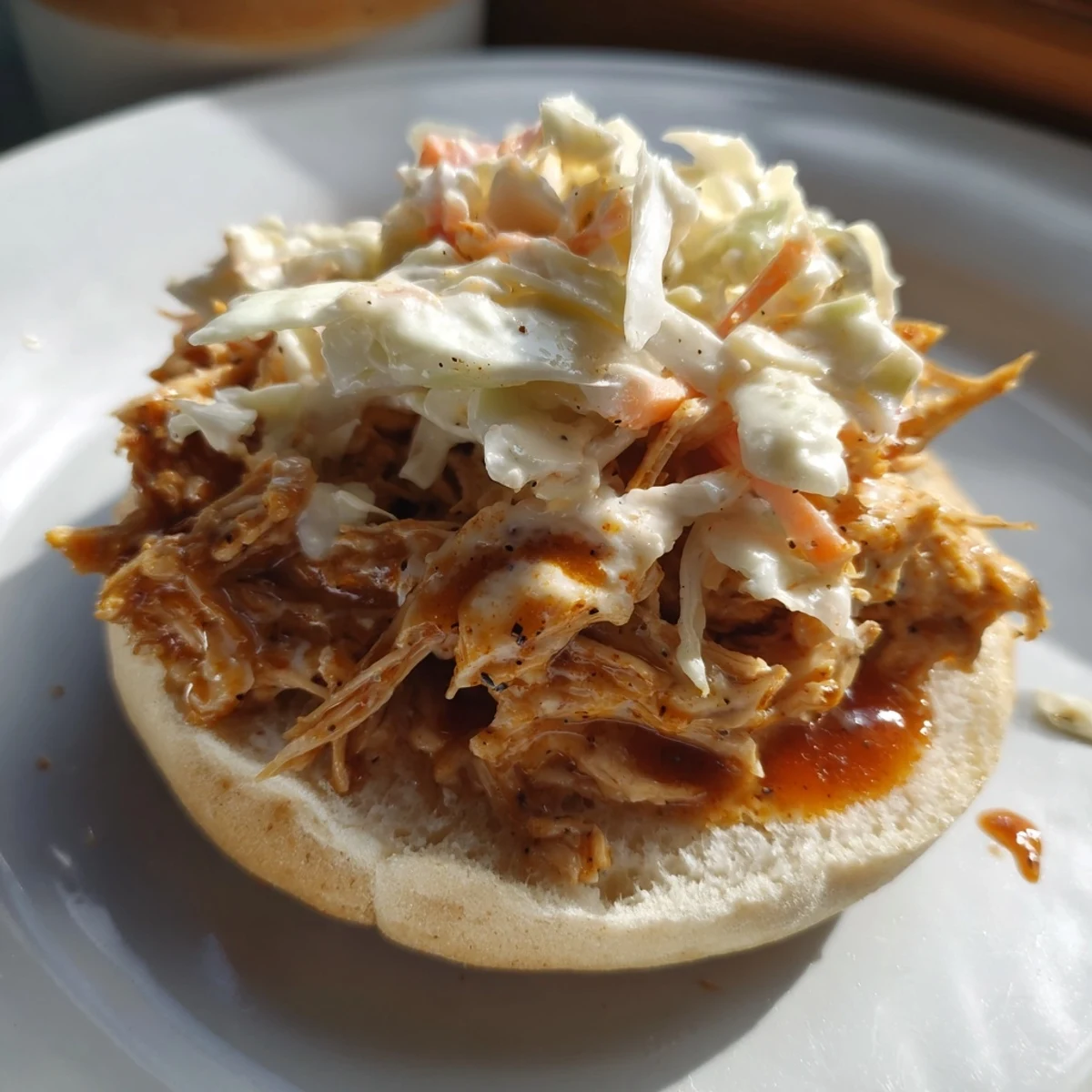 Golden buns filled with tender Tailgate Pulled Chicken Sandwiches, ready for a game day feast.