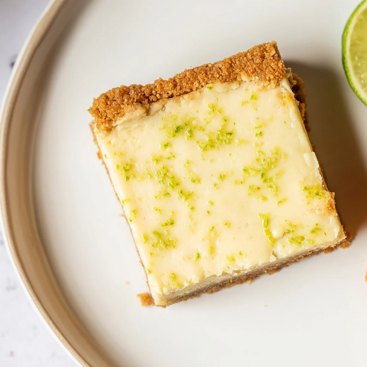 Homemade Lime Bars with Graham Cracker Crust served chilled on a wooden board, perfect for a refreshing summer dessert.