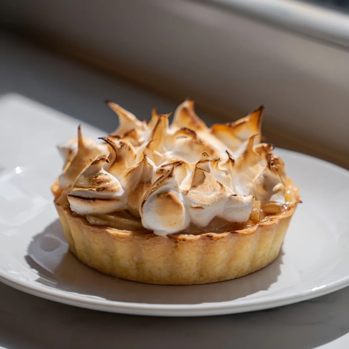 The warm Irish Apple Amber Tart with Meringue Top showcases tender apple filling under toasted meringue peaks.