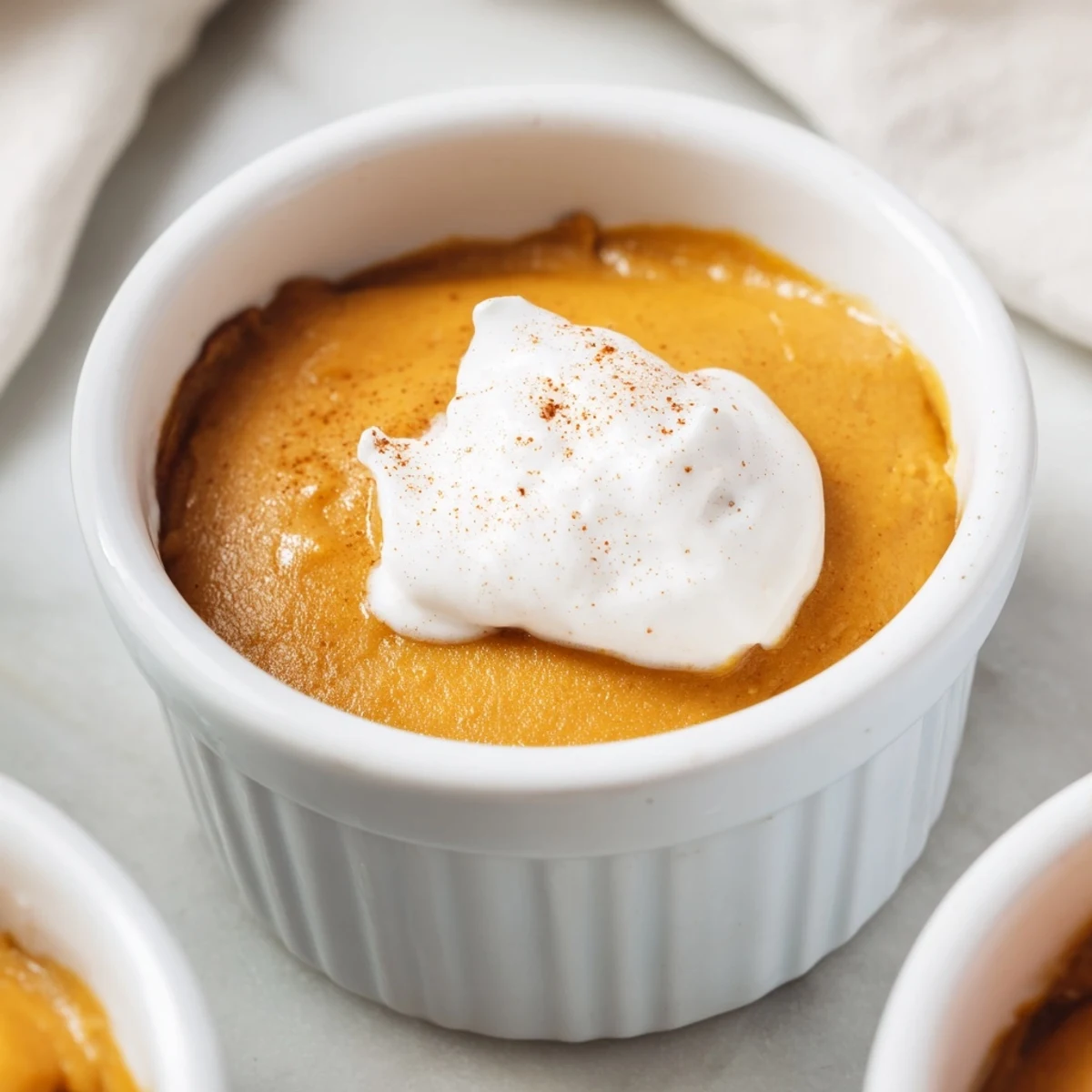 Chilled Effortless Baked Pumpkin Pudding in ramekins ready for a cozy autumn dessert serving.