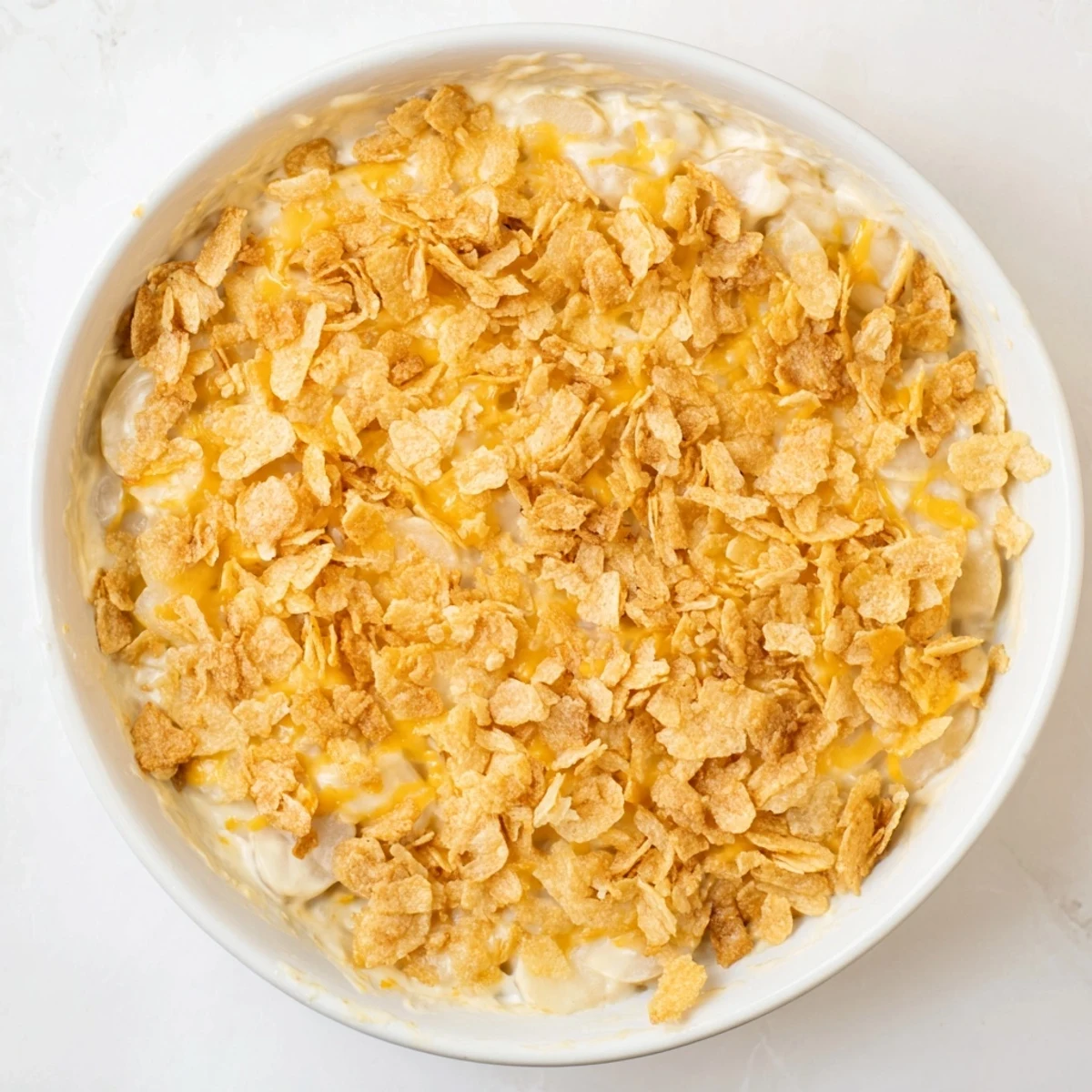 Golden Funeral Potatoes with Hashbrowns in a baking dish, ready for a potluck or holiday dinner.