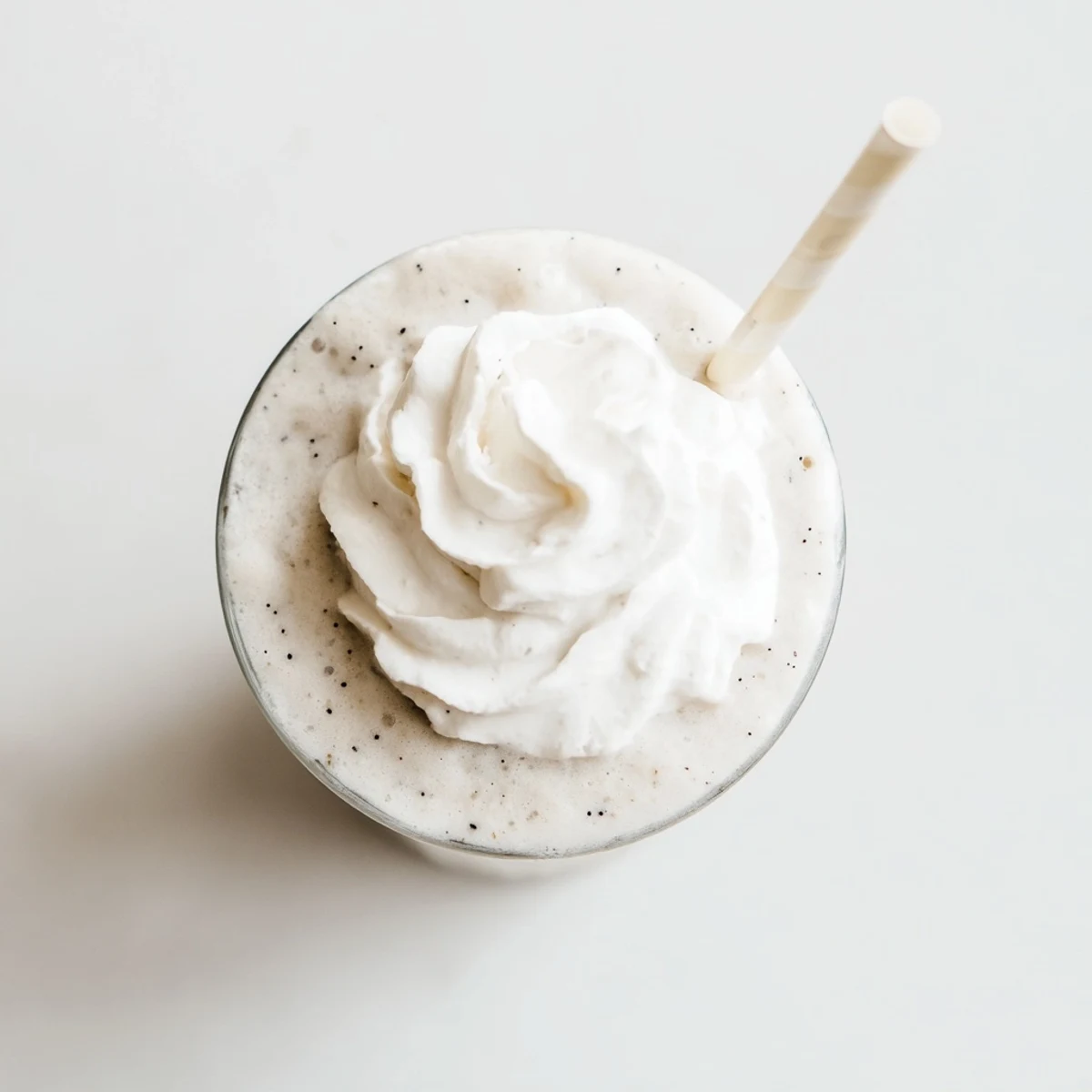 Creamy Vanilla Bean Frappuccino topped with whipped cream in a tall glass.