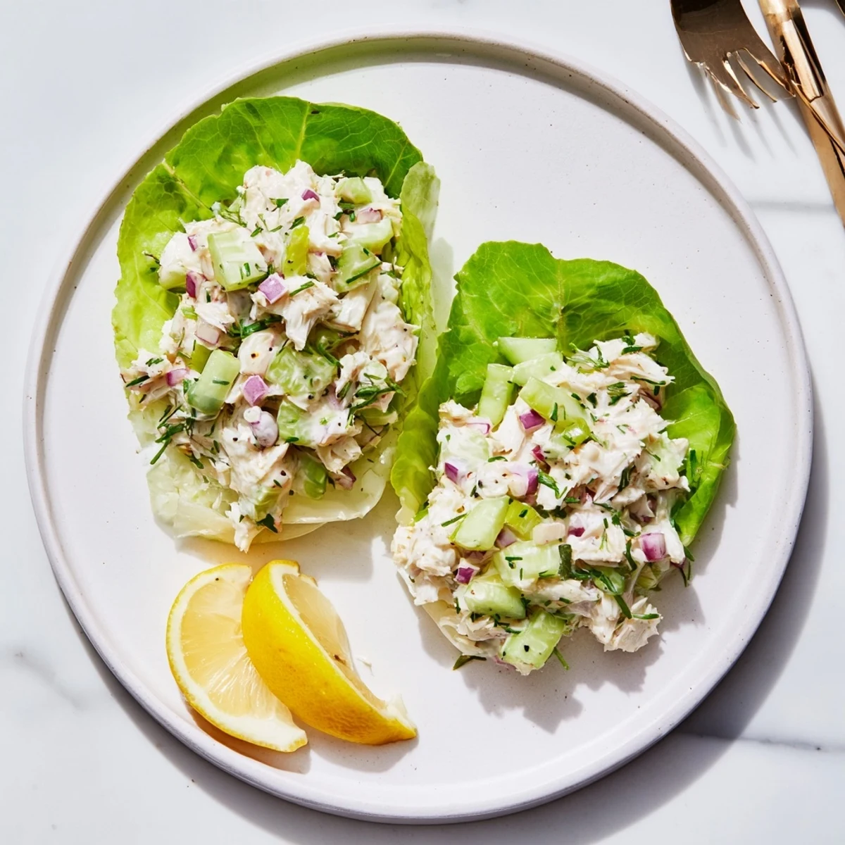 Fresh lump crab salad with crisp celery and cucumber, topped with creamy dressing and lemon wedges.