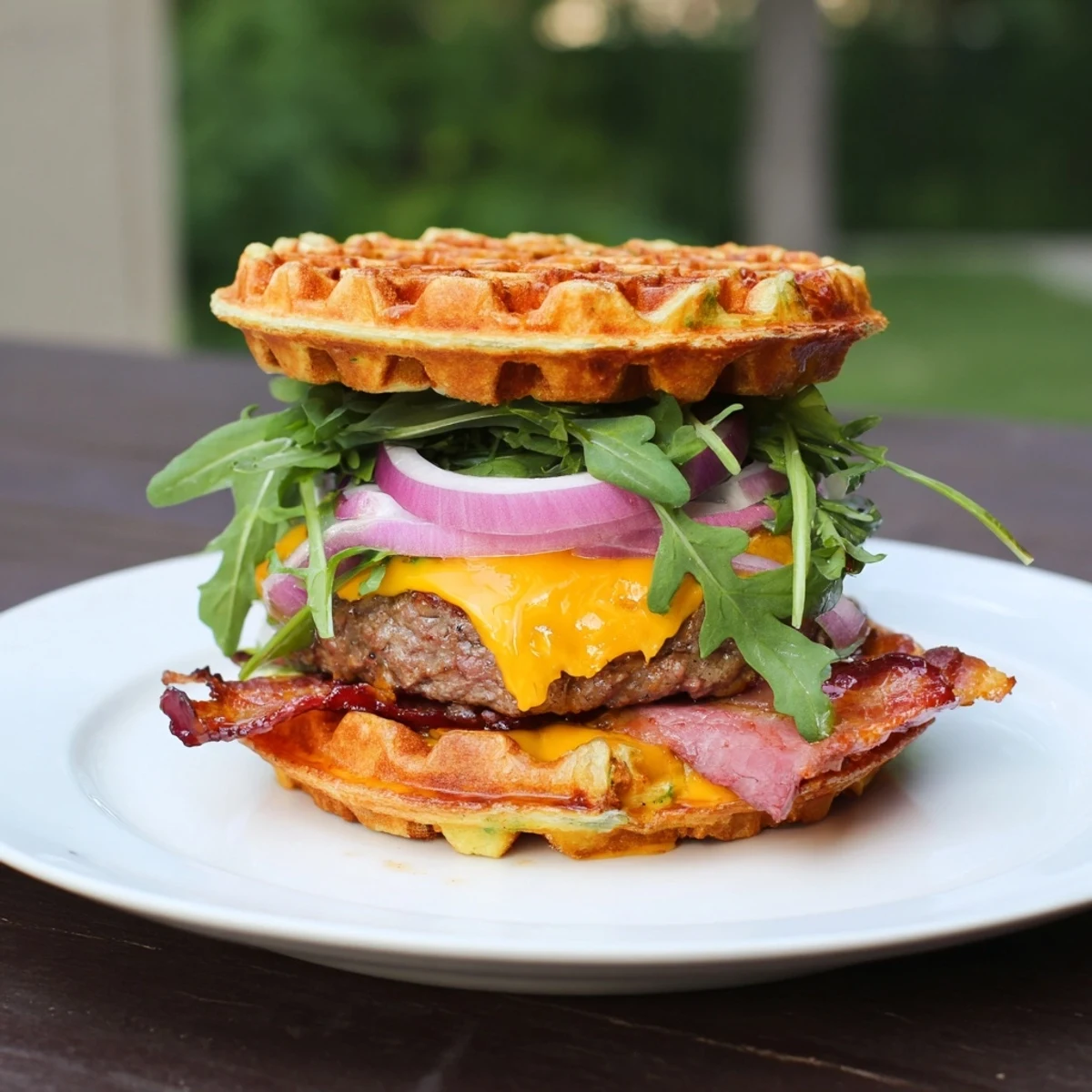 Decadent brunch burger featuring buttery toasted waffles cradling cheesy beef and caramelized bacon strips