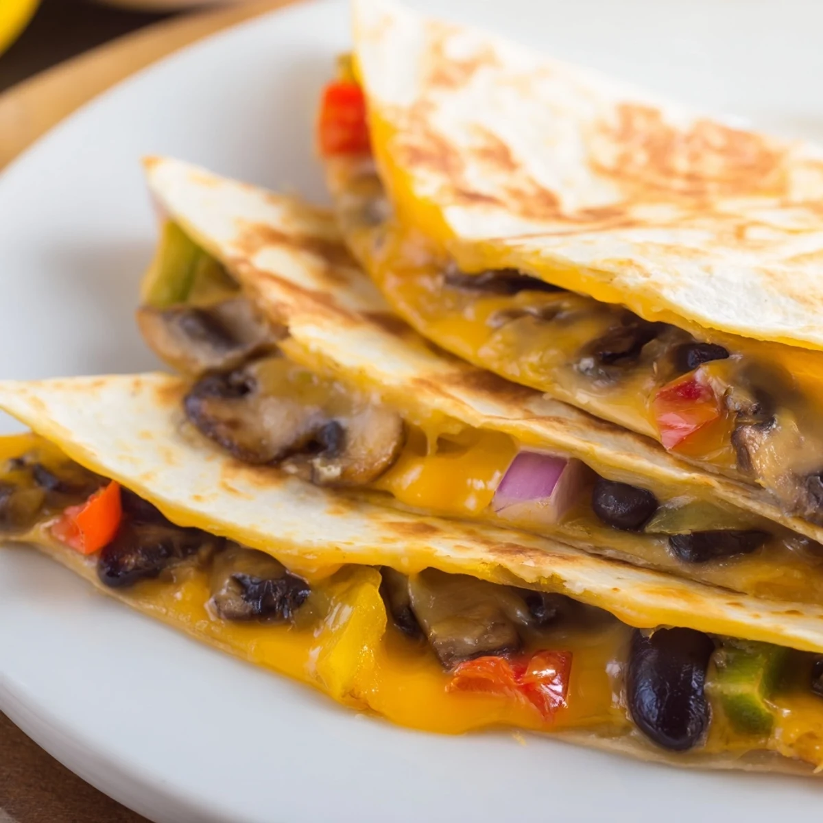 Golden brown quesadillas featuring melted cheddar and Monterey Jack cheese served with fresh salsa and guacamole