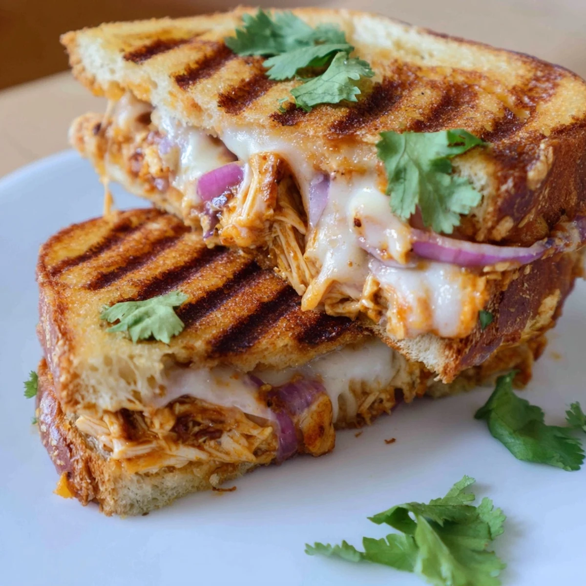 Golden BBQ chicken grilled cheese sandwich oozing melted cheddar and mozzarella on sourdough bread