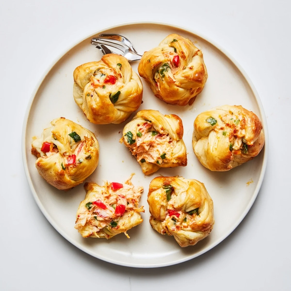 Golden brown crab and shrimp tortilla bombs with melted cheese and fresh cilantro garnish