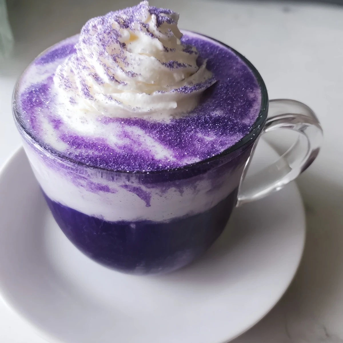 Filipino-inspired ube latte with espresso, steamed milk, and purple yam garnish