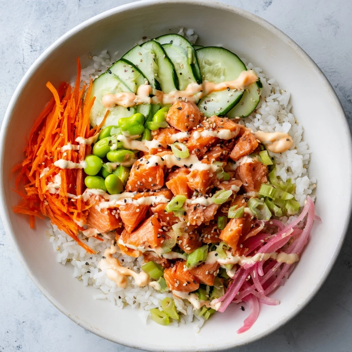 Vibrant easy salmon bowl featuring fluffy rice, crisp vegetables, and zesty lime-spiked sauce