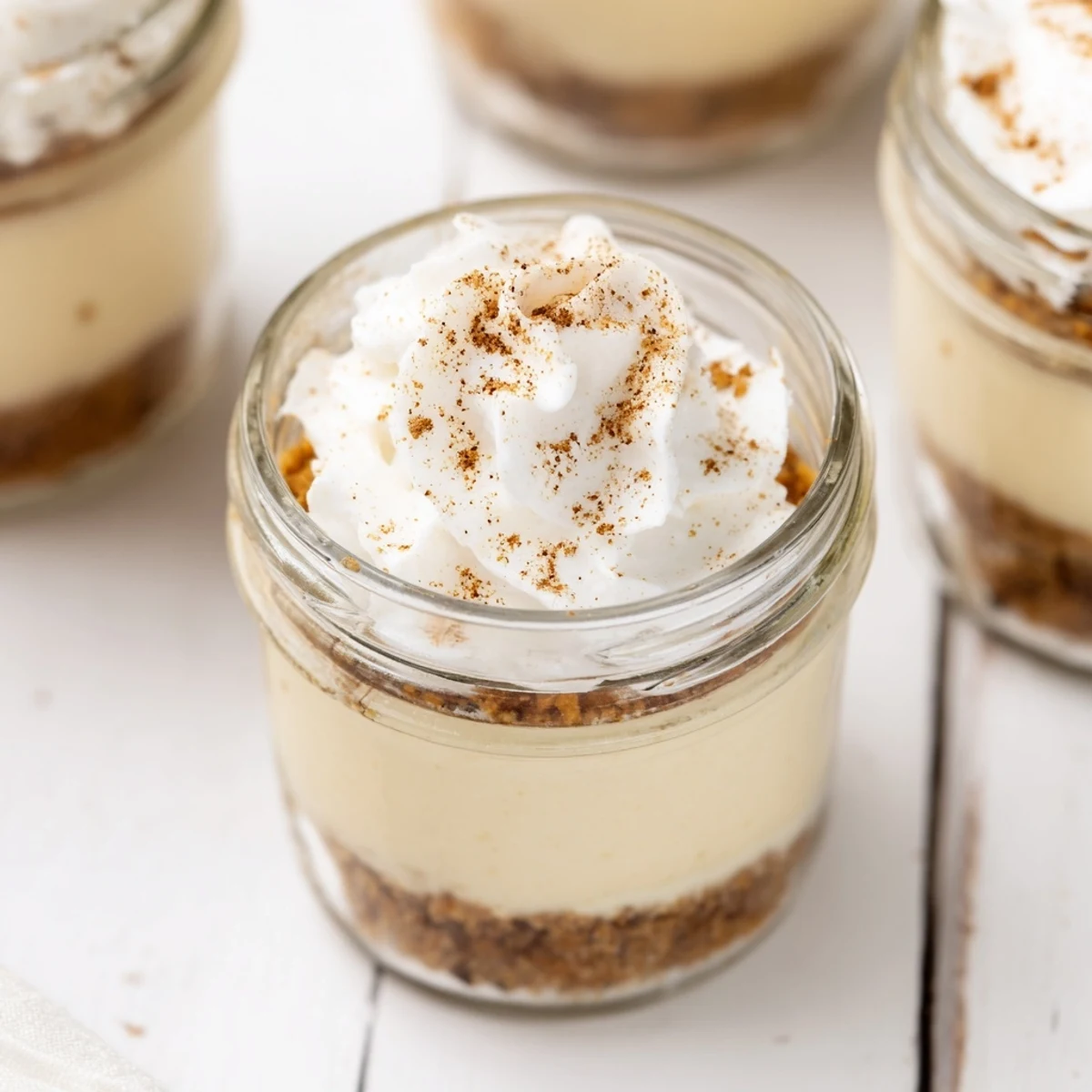 Portable no bake mini mason jar spiced cheesecakes ready for effortless entertaining and dessert buffets