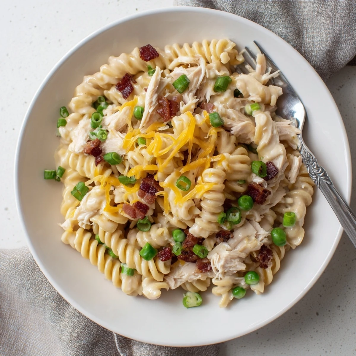 Creamy slow cooker Crack Chicken Casserole featuring tender pasta and shredded ranch-seasoned chicken