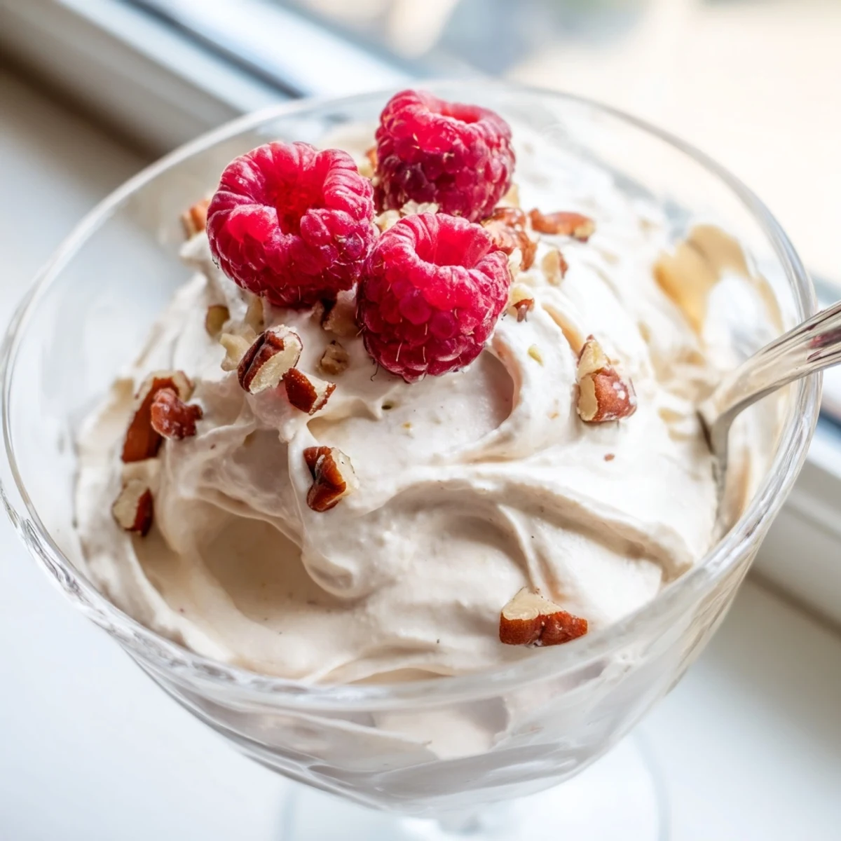 Light and airy keto cheesecake fluff spooned into individual parfait cups