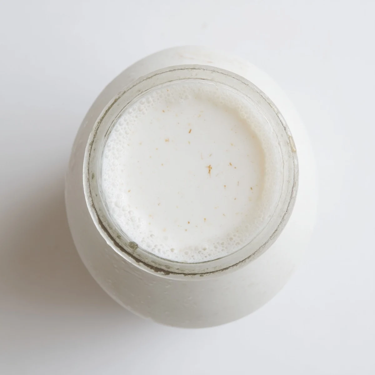 Homemade coconut milk in a glass jar showing creamy white texture
