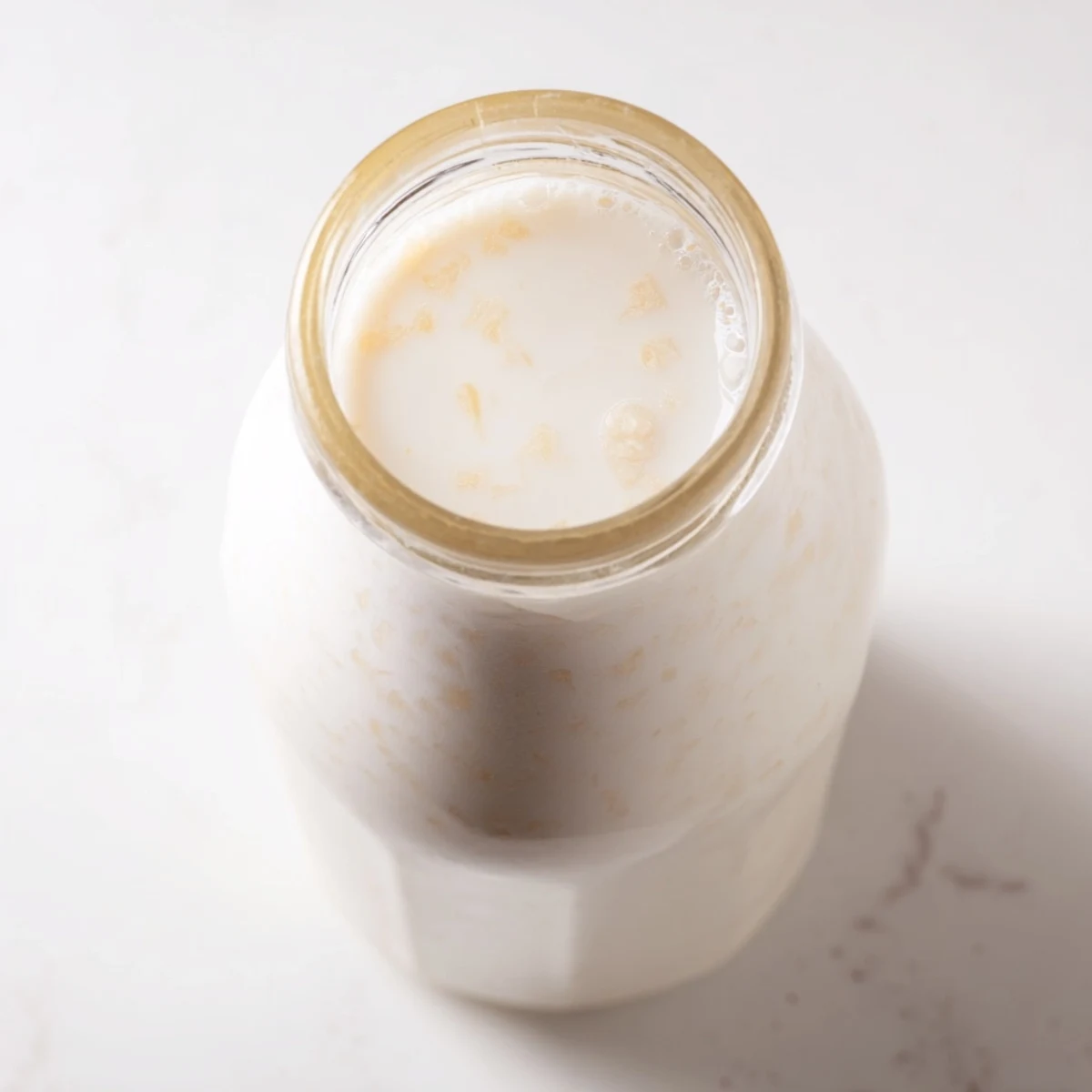 DIY coconut milk recipe with blended coconut mixture and straining process