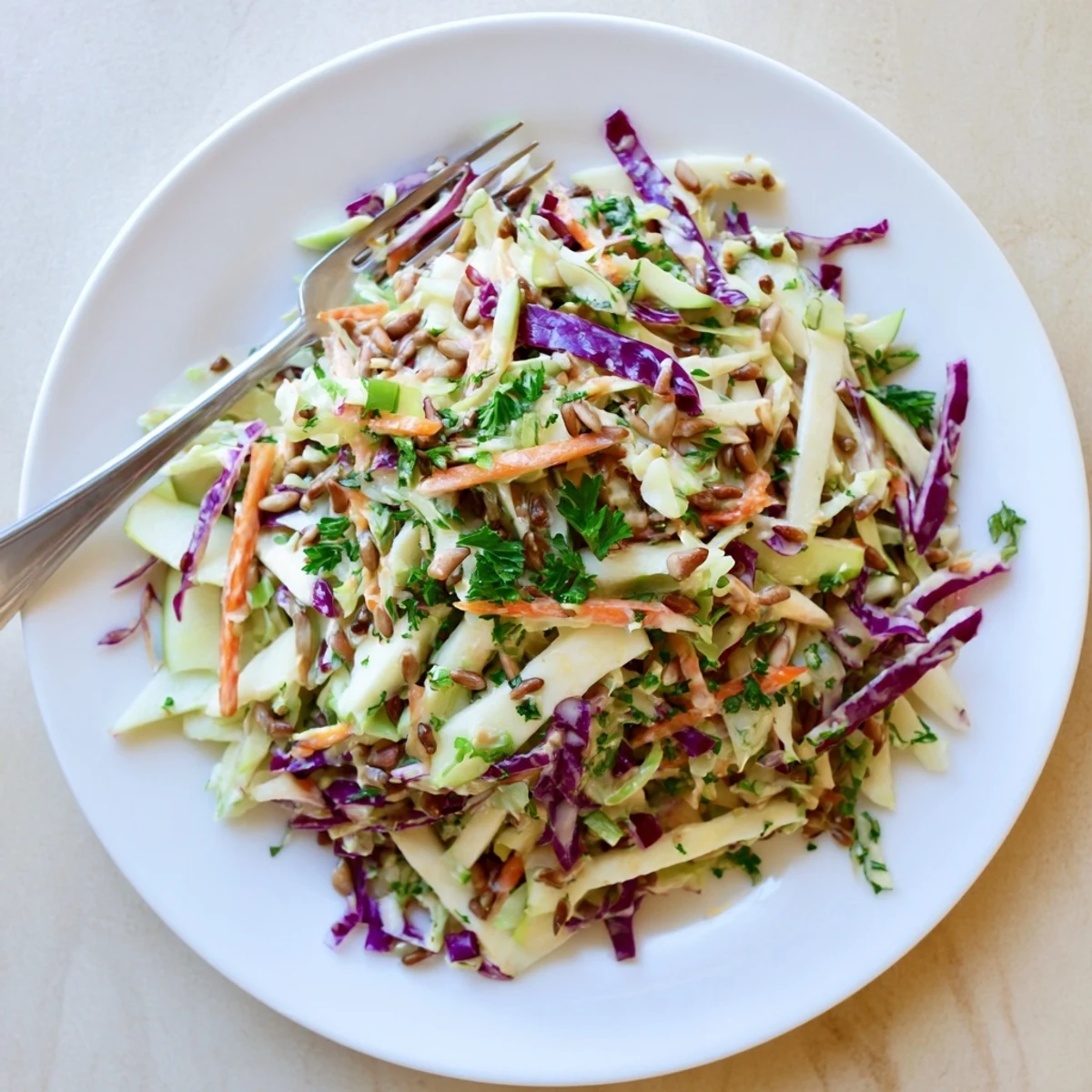 Crisp apple coleslaw featuring julienned apples and shredded carrots coated in honey mustard dressing