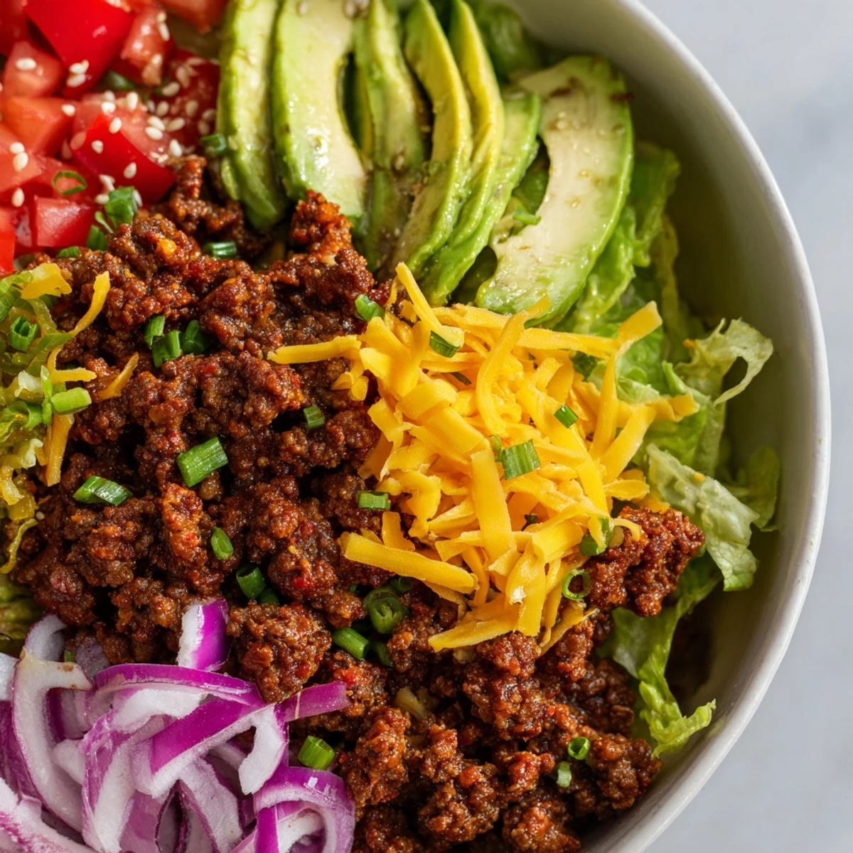 Easy low-carb burger bowls layered with seasoned beef, colorful toppings, and melted cheese for a satisfying meal.