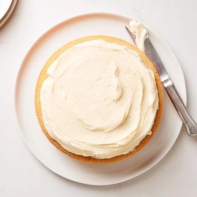 A close up of moist Perfect Vanilla Cake with smooth buttercream, ideal for an everyday treat.