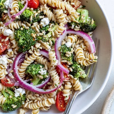 Bright Broccoli Pasta Salad studded with cherry tomatoes, crisp florets, feta.